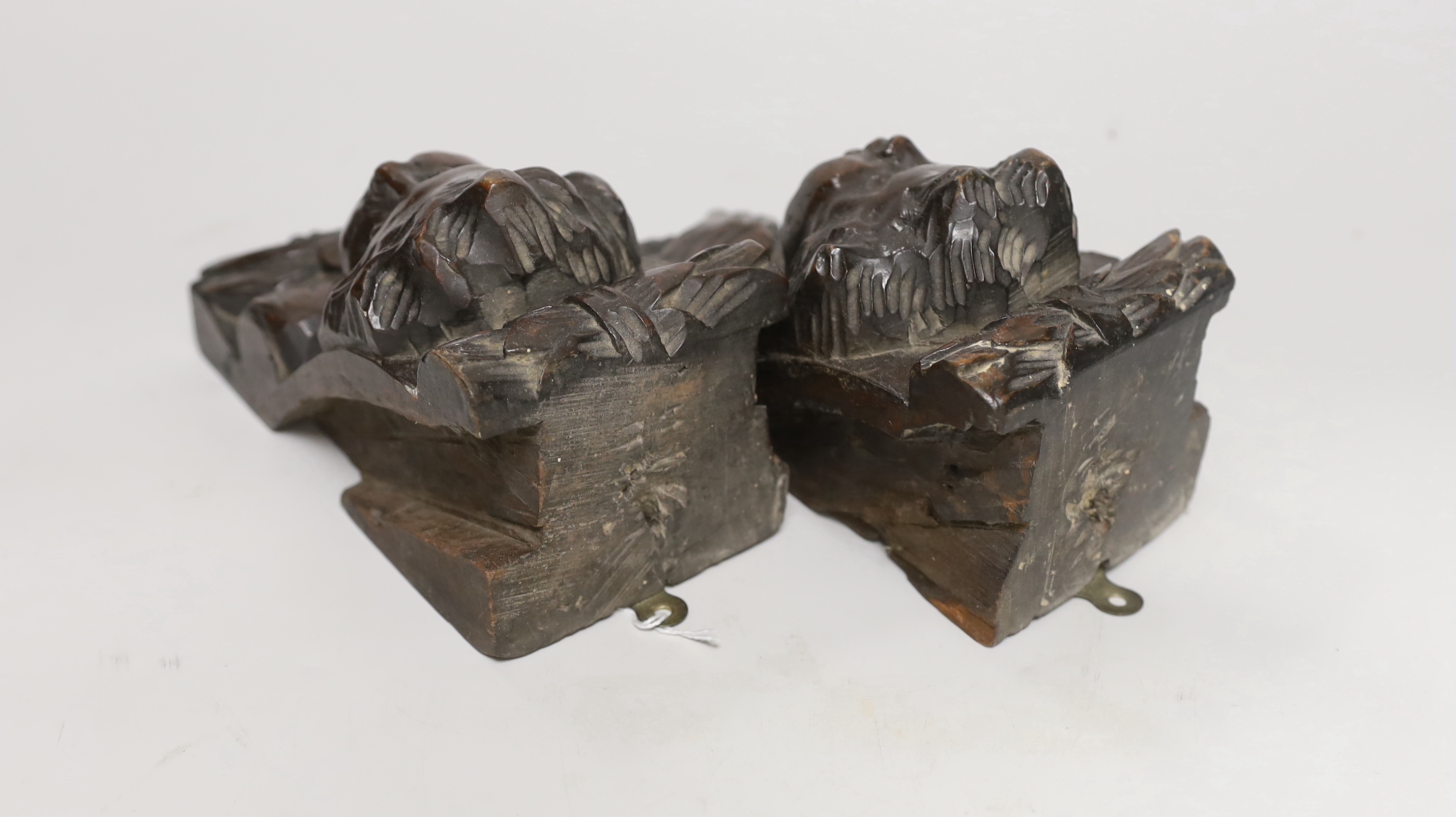 A pair of Italian carved walnut putti corbels, 18cm high
